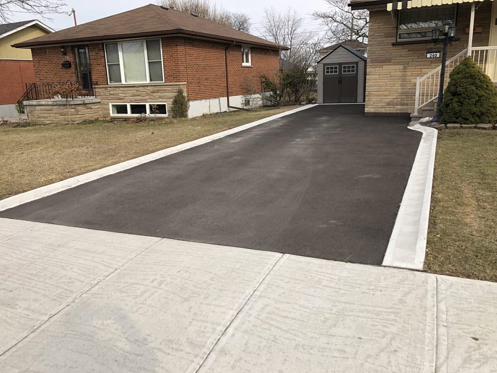 Asphalt driveway with concrete curb