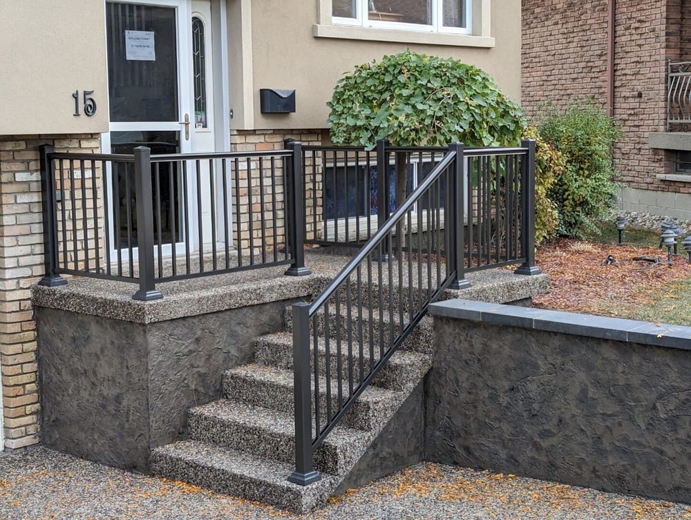 Concrete porch with black picket railing