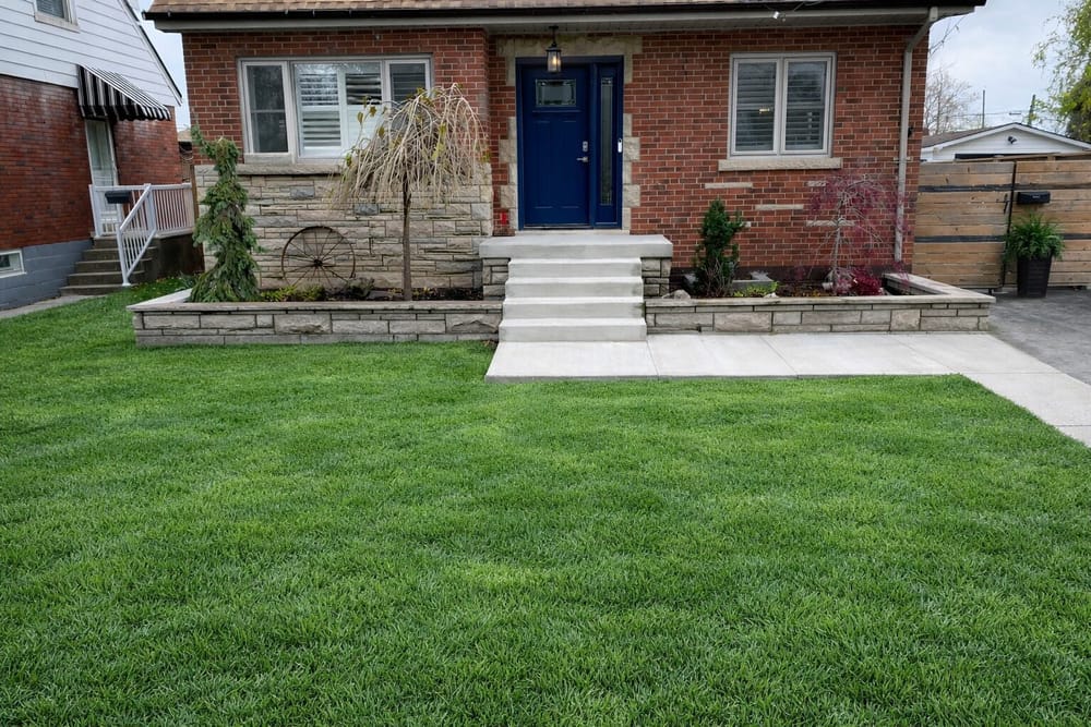 Brick home with stone steps and blue front door
