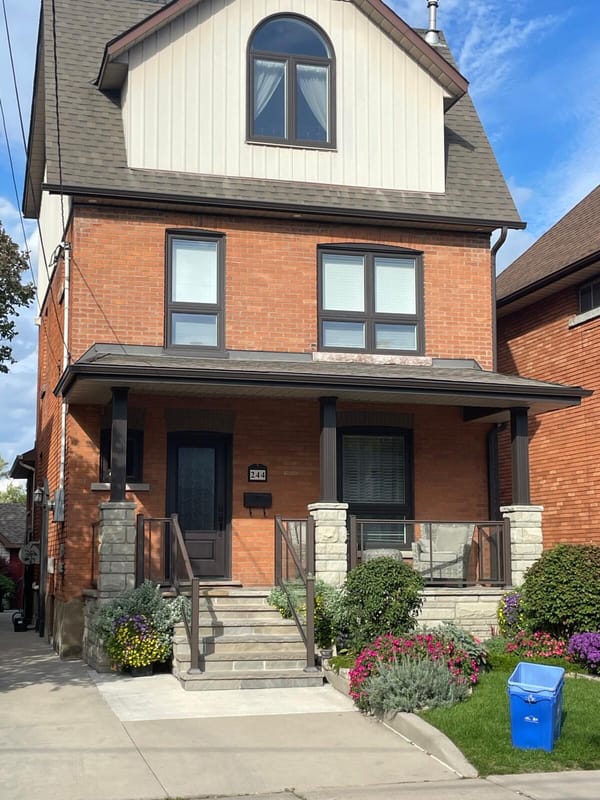 Three-storey brick home with stone column porch renovation