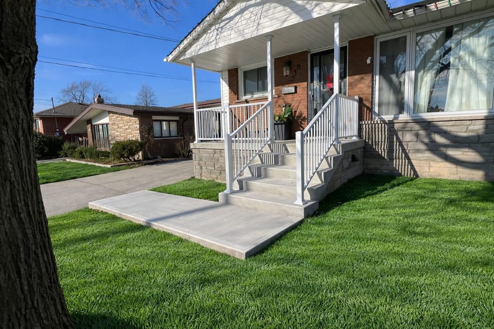 White railing porch with concrete walkway and landing