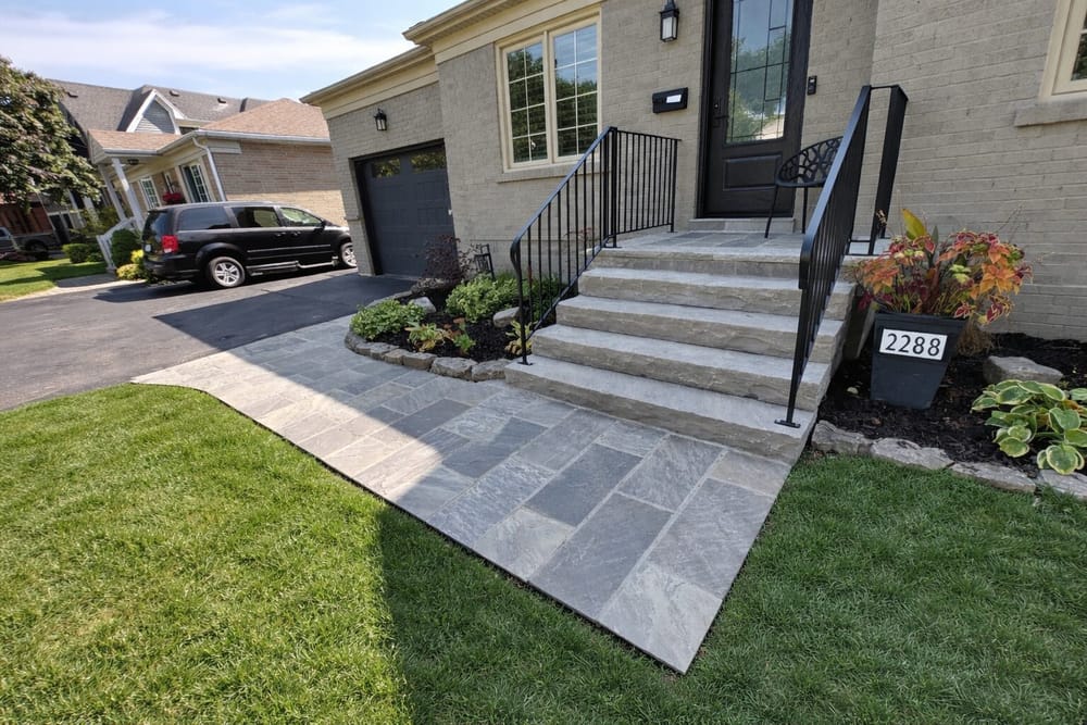 Large flagstone walkway and steps with black iron railing
