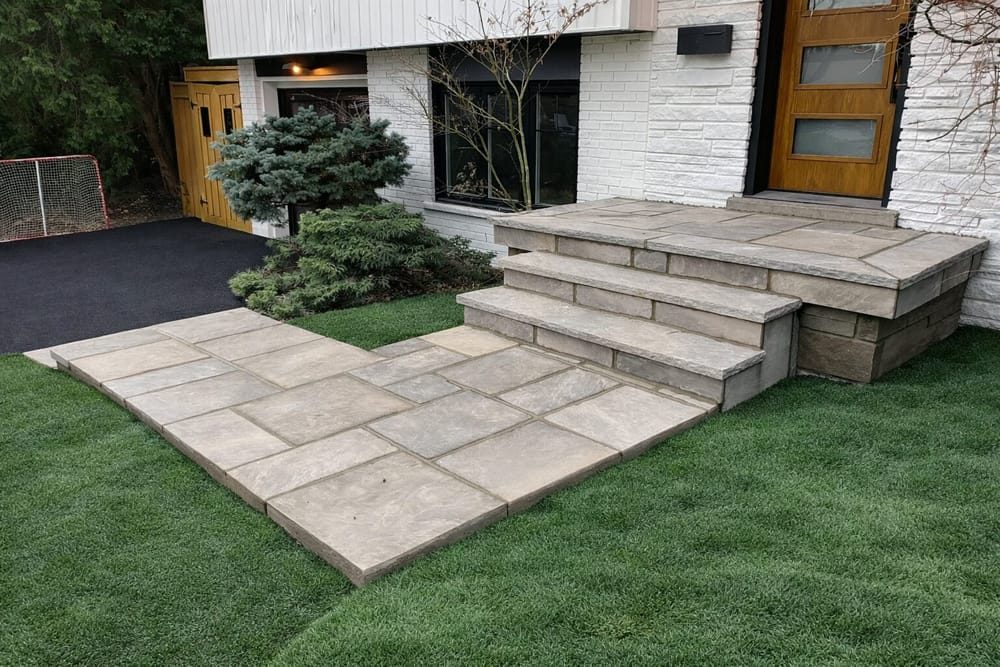 Concrete slab walkway and porch steps with modern home