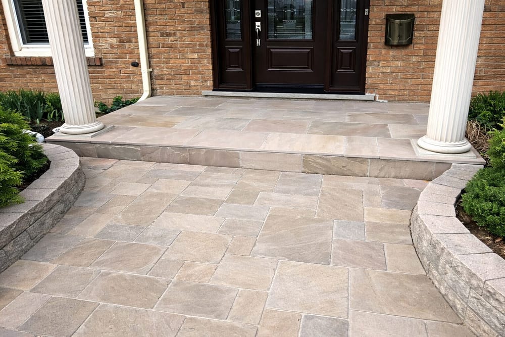 Flagstone porch with double doors and curved stone walls