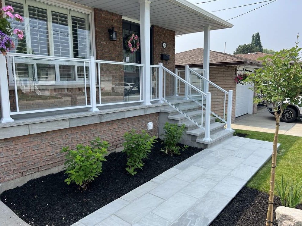 Glass railing porch with stone walkway